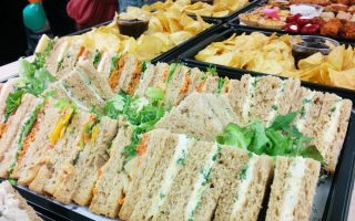 A selection of sandwiches, crisps, savoury snacks and dips. Corporate catering for meetings, lunches and parties.  Close up image of food.